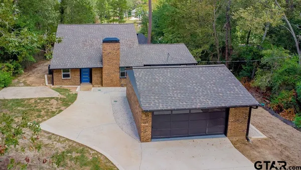 an aerial view of a house with yard and entertaining space