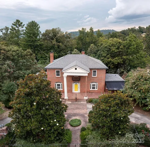 an aerial view of a house with yard and outdoor seating