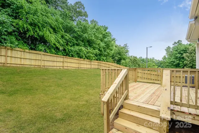 a front view of a house with a garden and deck