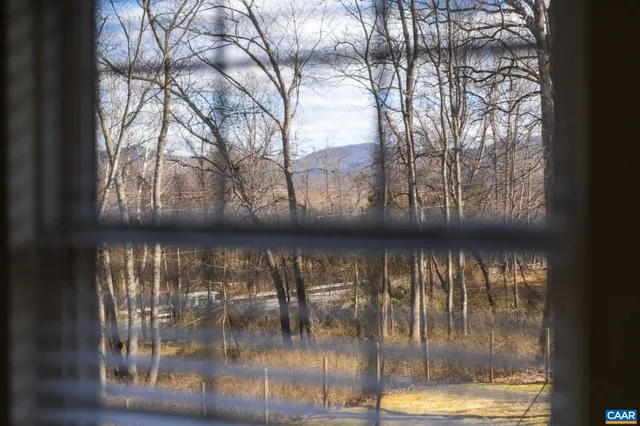 a bathroom with a sink a toilet and a window