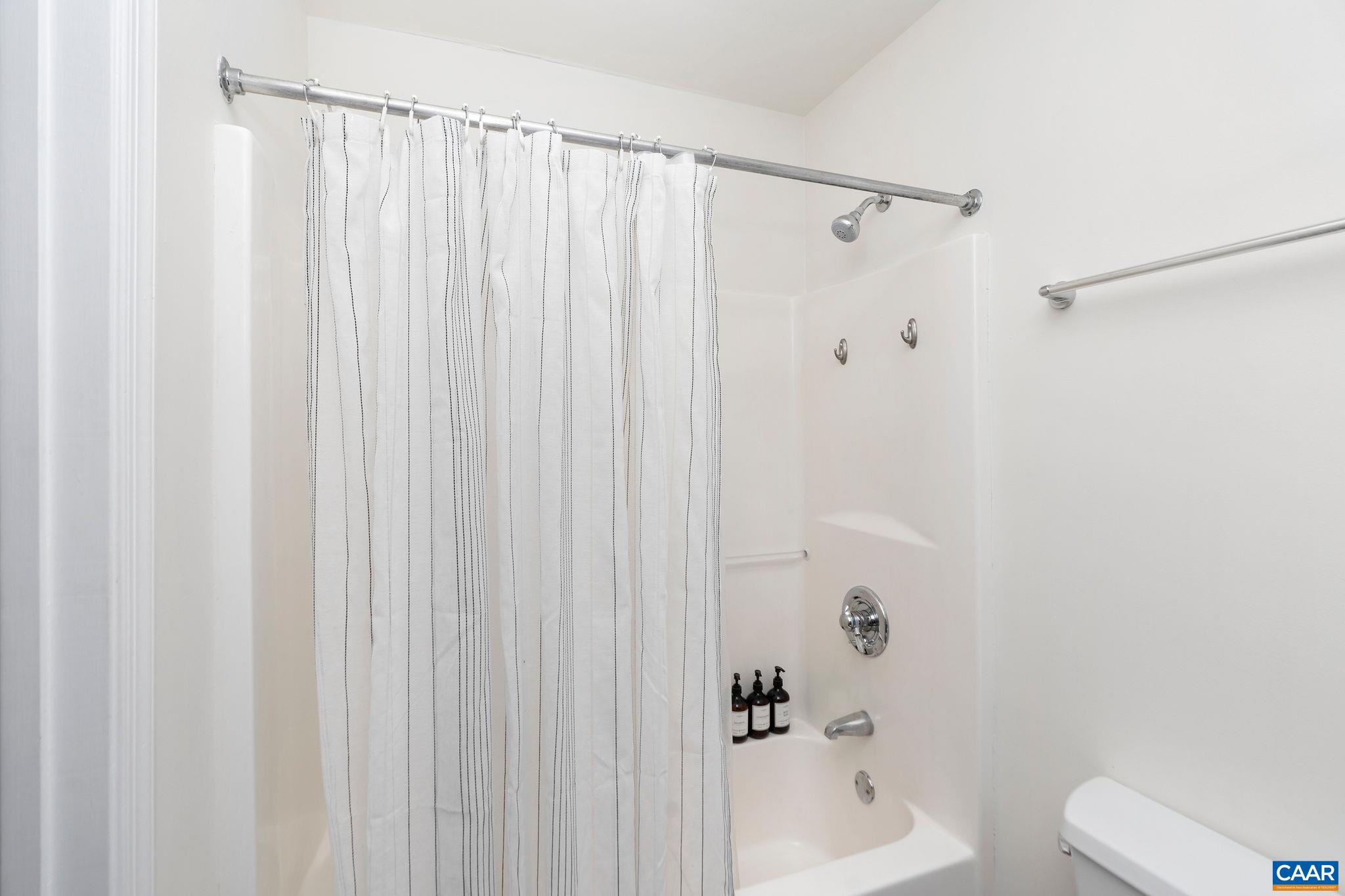 57 Pounding Branch Road Afton, VA 22920 - Photo 21 of 31 a bathroom with a shower curtain and a toilet