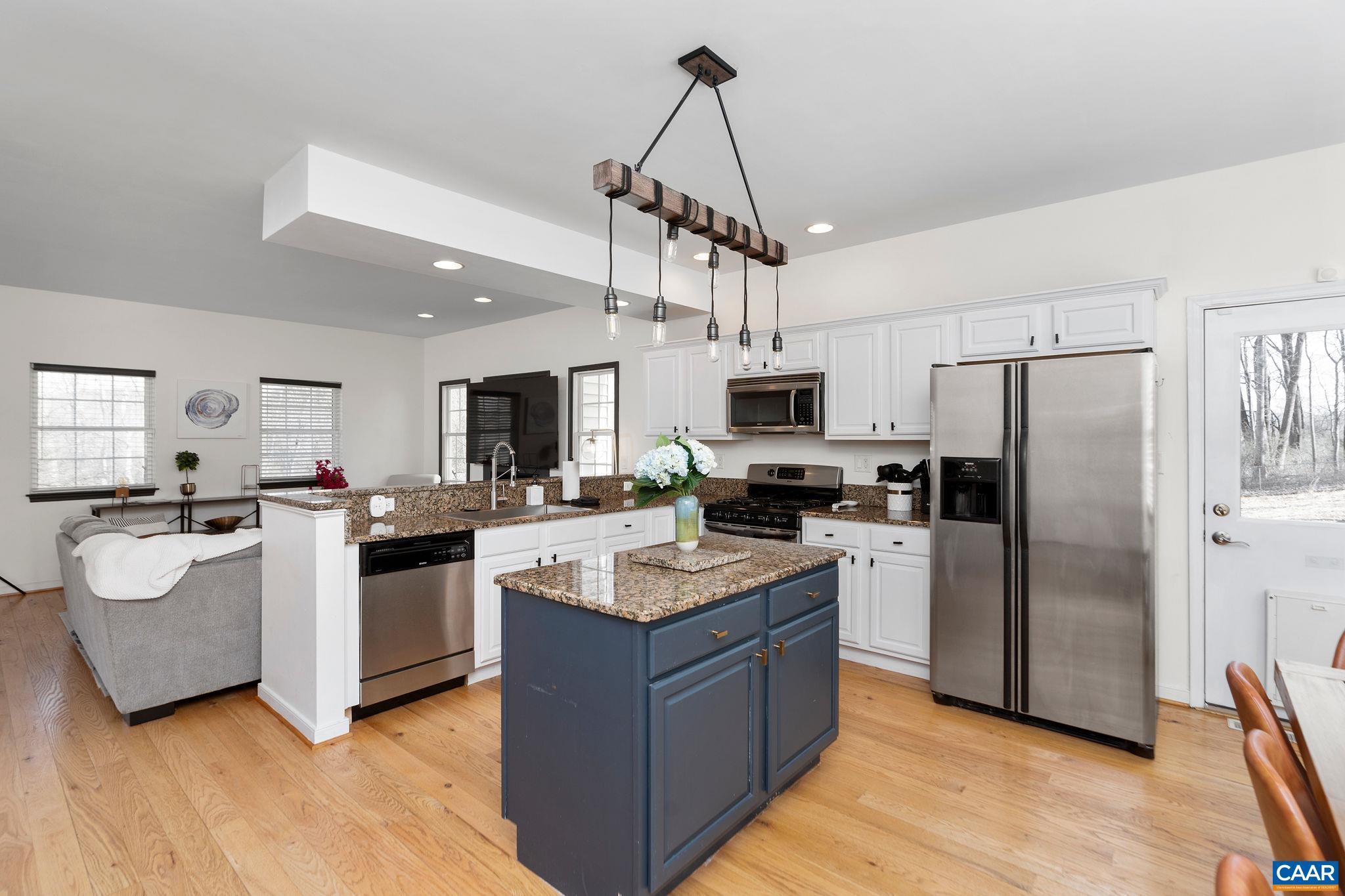 57 Pounding Branch Road Afton, VA 22920 - Photo 3 of 31 a kitchen with a refrigerator a sink dishwasher a oven with a dining table and chairs