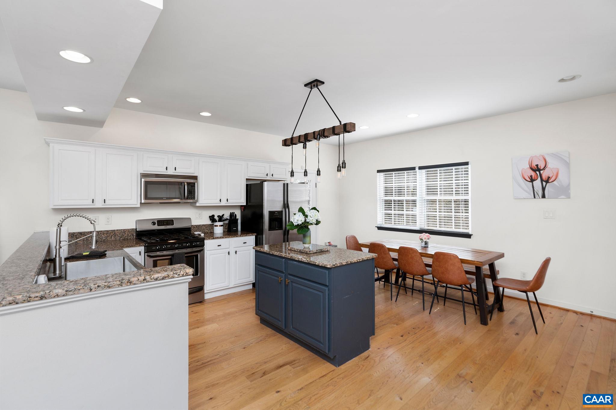 57 Pounding Branch Road Afton, VA 22920 - Photo 5 of 31 a kitchen with stainless steel appliances granite countertop a stove top oven a sink dishwasher a dining table and chairs with wooden floor