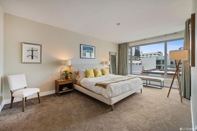 a bedroom with a bed and a couch