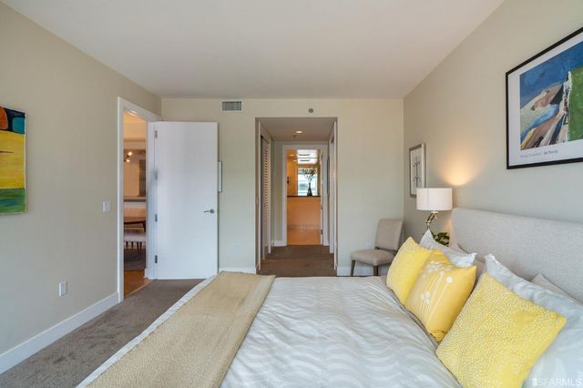 a bedroom with a bed and lamp