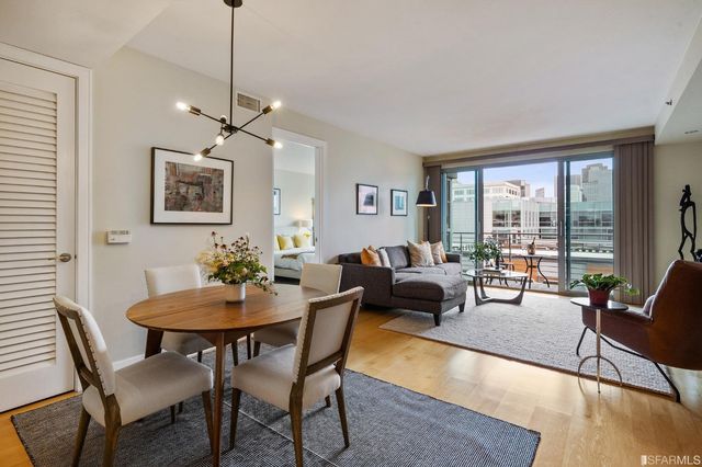 a living room with furniture two window and a dining table