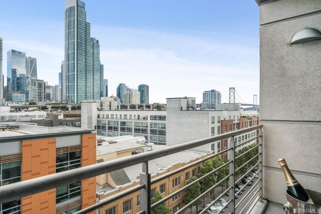 a view of swimming pool with outdoor seating and city view