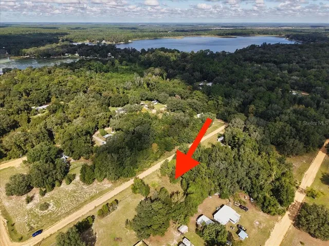 a aerial view of a houses with a yard