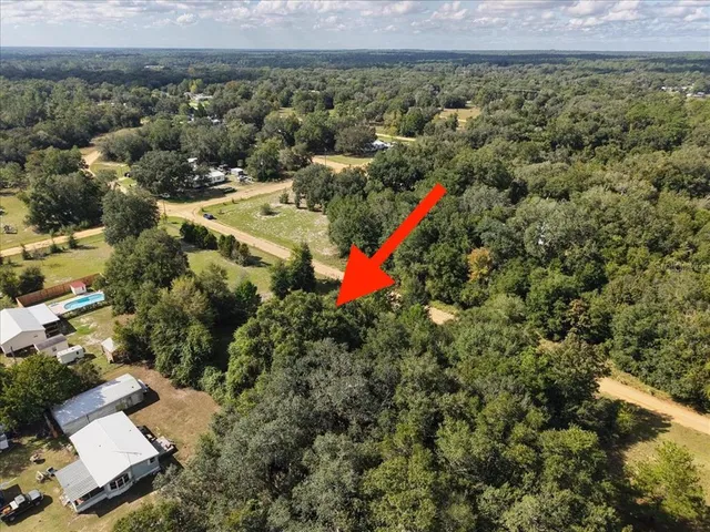 an aerial view of a houses with a yard