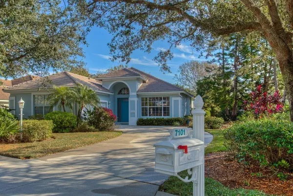 a front view of house with yard and green space
