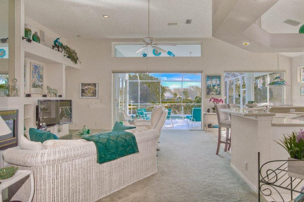 7101 Victoria Circle University Park, FL 34201 - Photo 12 of 31 a living room with furniture a chandelier and a floor to ceiling window