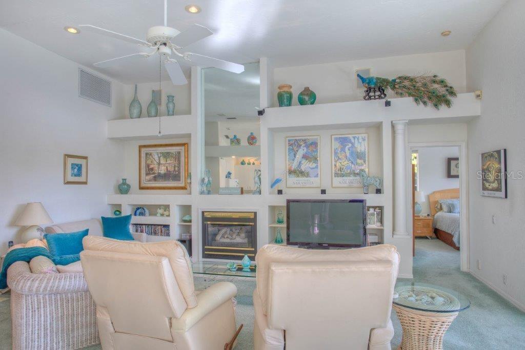 7101 Victoria Circle University Park, FL 34201 - Photo 15 of 31 a living room with furniture a fireplace and a table