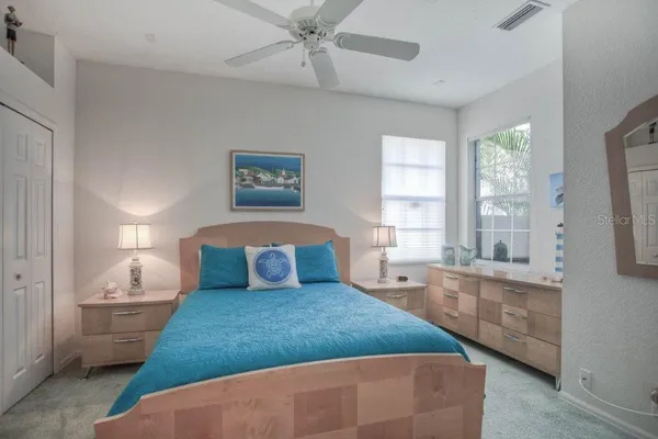 a bedroom with a large bed and a window