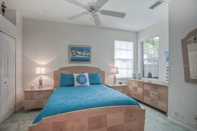 a bedroom with a large bed and a window