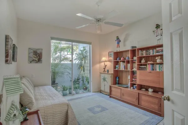 a living room with furniture cabinets and window
