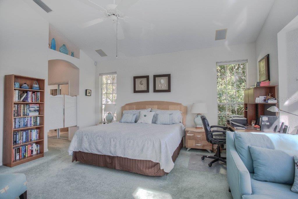 7101 Victoria Circle University Park, FL 34201 - Photo 20 of 31 a bedroom with a bed a book shelf and a window
