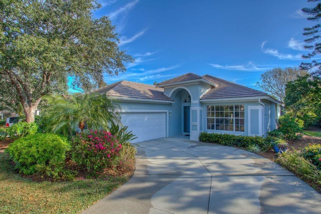 7101 Victoria Circle University Park, FL 34201 - Photo 2 of 31 a front view of a house with a garden