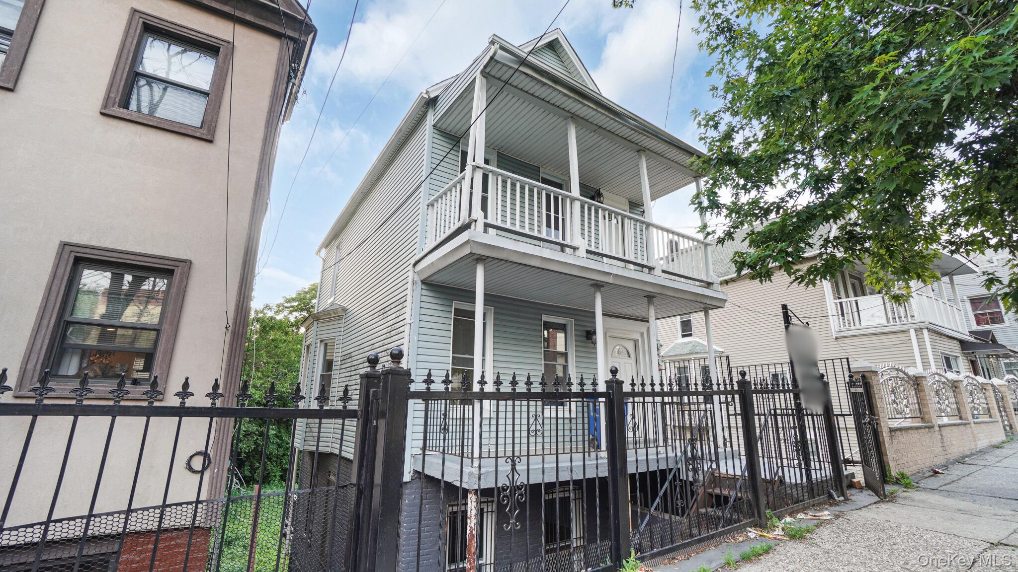 1513 Rosedale Avenue Bronx, NY 10460 - Photo 17 of 29 View of front of property with a fenced front yard, a gate, and a balcony