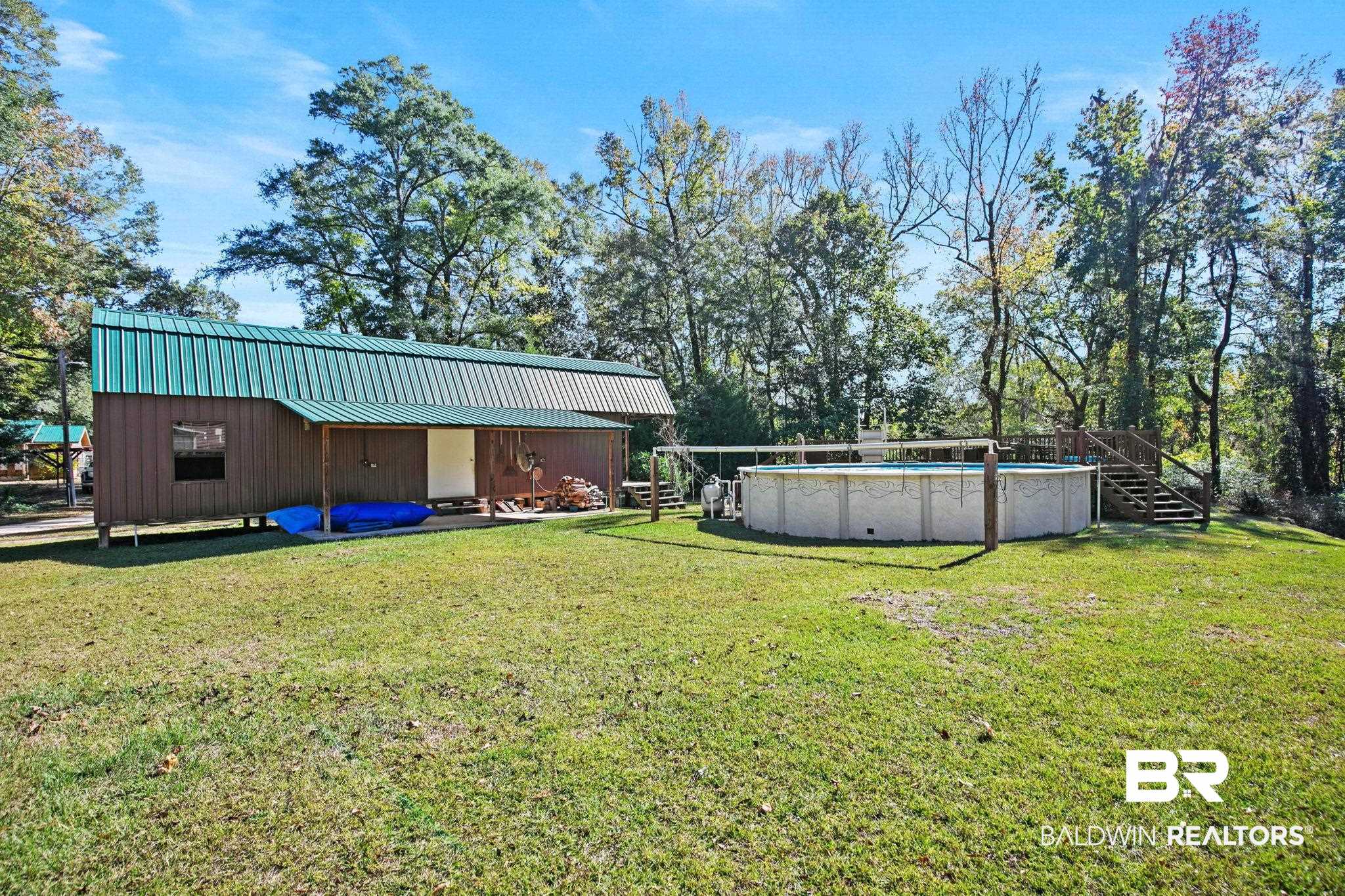 724 Rowell Lane Brewton, AL 36426 - Photo 28 of 40 View of grassy yard with an outdoor pool and stairway