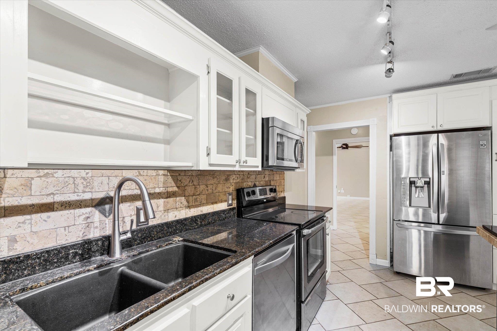 3724 Claridge Road South Mobile, AL 36608 - Photo 13 of 42 Kitchen with a textured ceiling, white cabinets, stainless steel appliances, open shelves, and glass insert cabinets