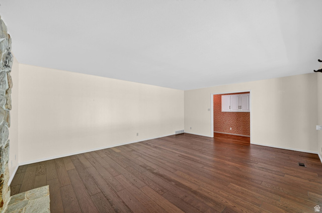 3120 North Apache Way Provo, UT 84604 - Photo 19 of 58 Expansive room featuring rich wood-finish flooring, light-toned walls, and a stone-clad fireplace