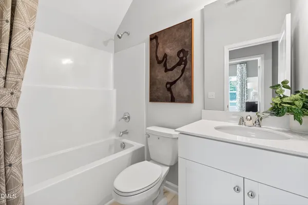 a white toilet sitting next to a bath tub