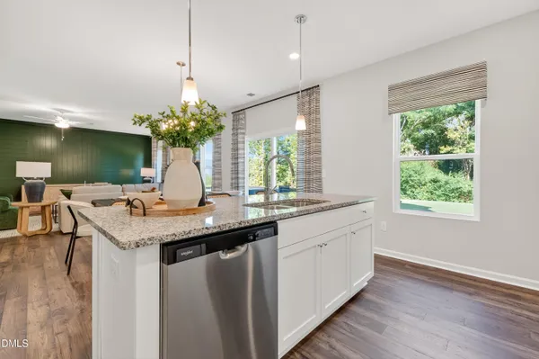a kitchen with stainless steel appliances granite countertop a sink and a large window