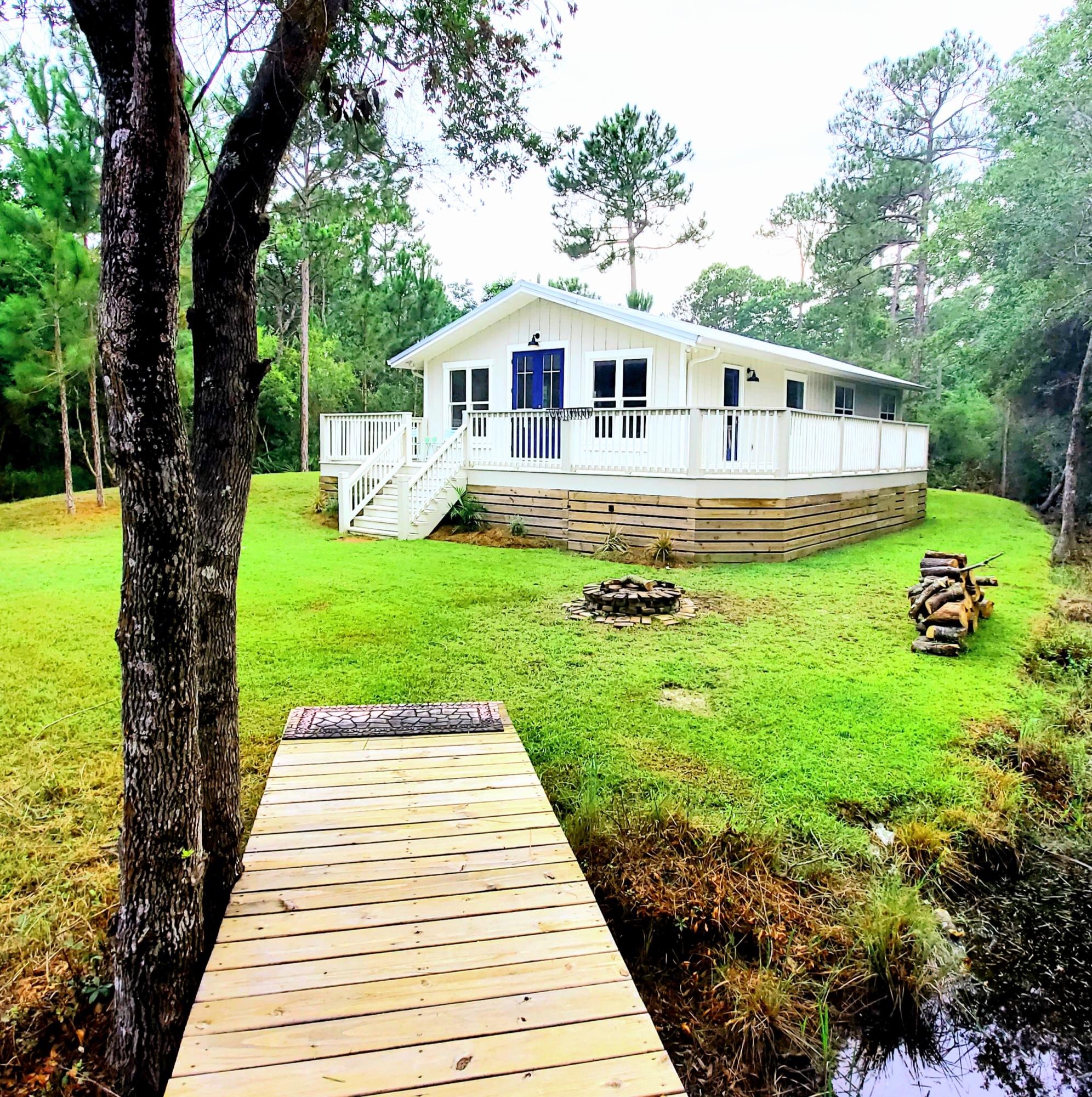 59 Chelsey Lane Santa Rosa Beach, FL 32459 - Photo 3 of 31 a front view of a house with garden
