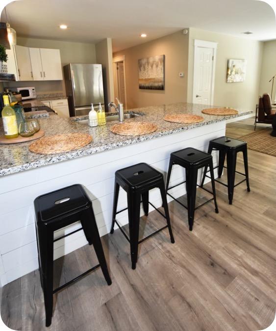 59 Chelsey Lane Santa Rosa Beach, FL 32459 - Photo 6 of 31 a kitchen with stainless steel appliances granite countertop table chairs sink refrigerator and granite counter top