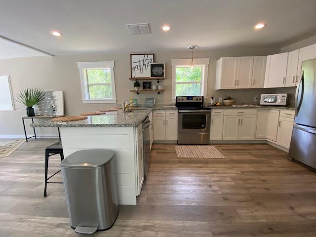 59 Chelsey Lane Santa Rosa Beach, FL 32459 - Photo 7 of 31 a kitchen with a sink cabinets and wooden floor