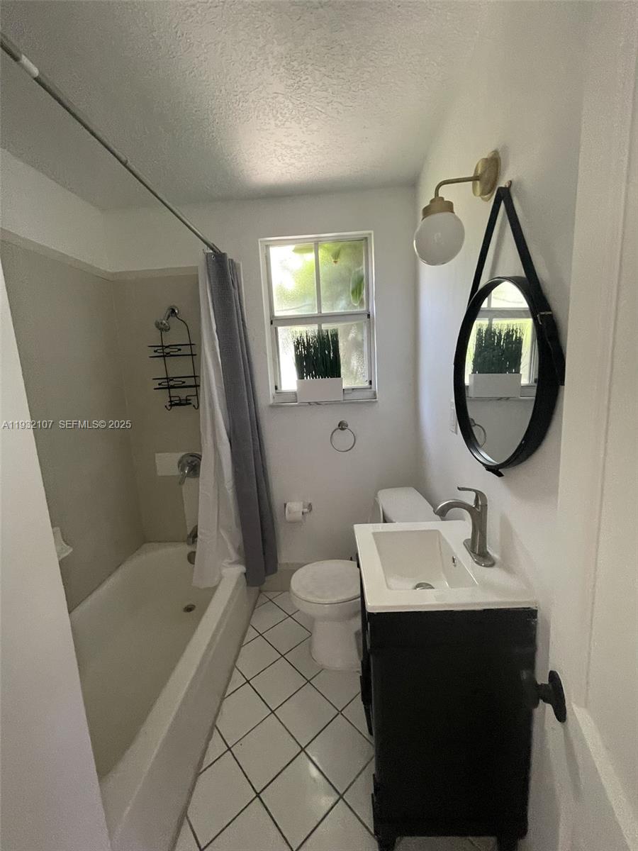 210 Northeast 110th Street Miami, FL 33161 - Photo 12 of 26 a bathroom with a sink a toilet and shower