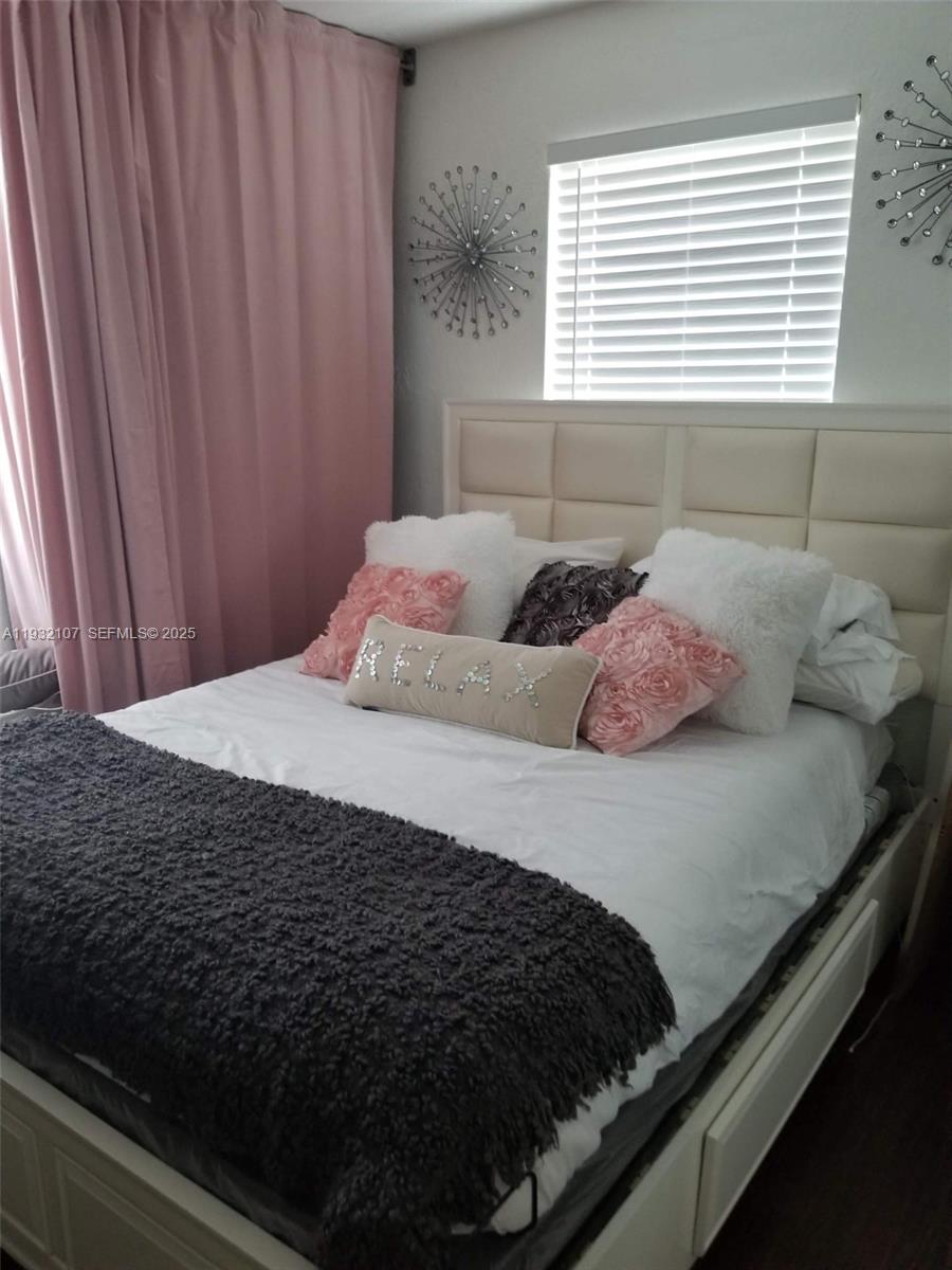 210 Northeast 110th Street Miami, FL 33161 - Photo 22 of 26 a bedroom with a bed and a window