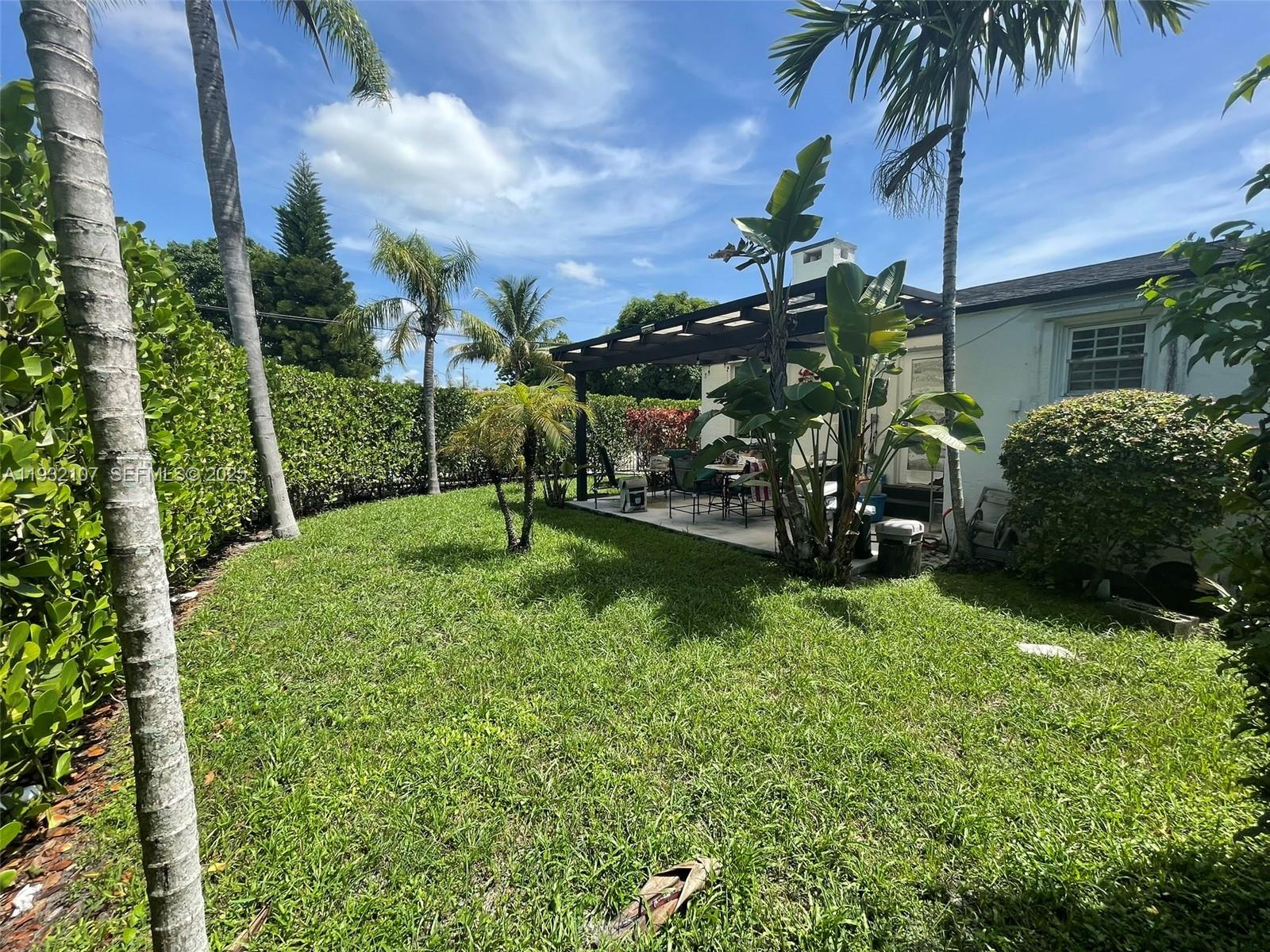 210 Northeast 110th Street Miami, FL 33161 - Photo 10 of 26 a view of a house with a yard