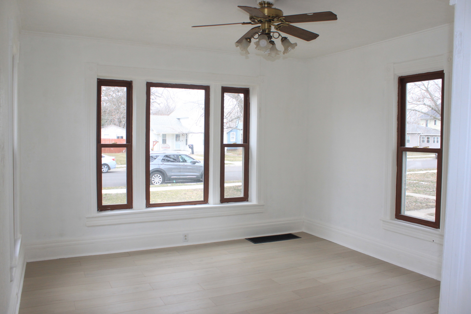 511 3rd Avenue Rock Falls, IL 61071 - Photo 3 of 9 an empty room with windows and fan