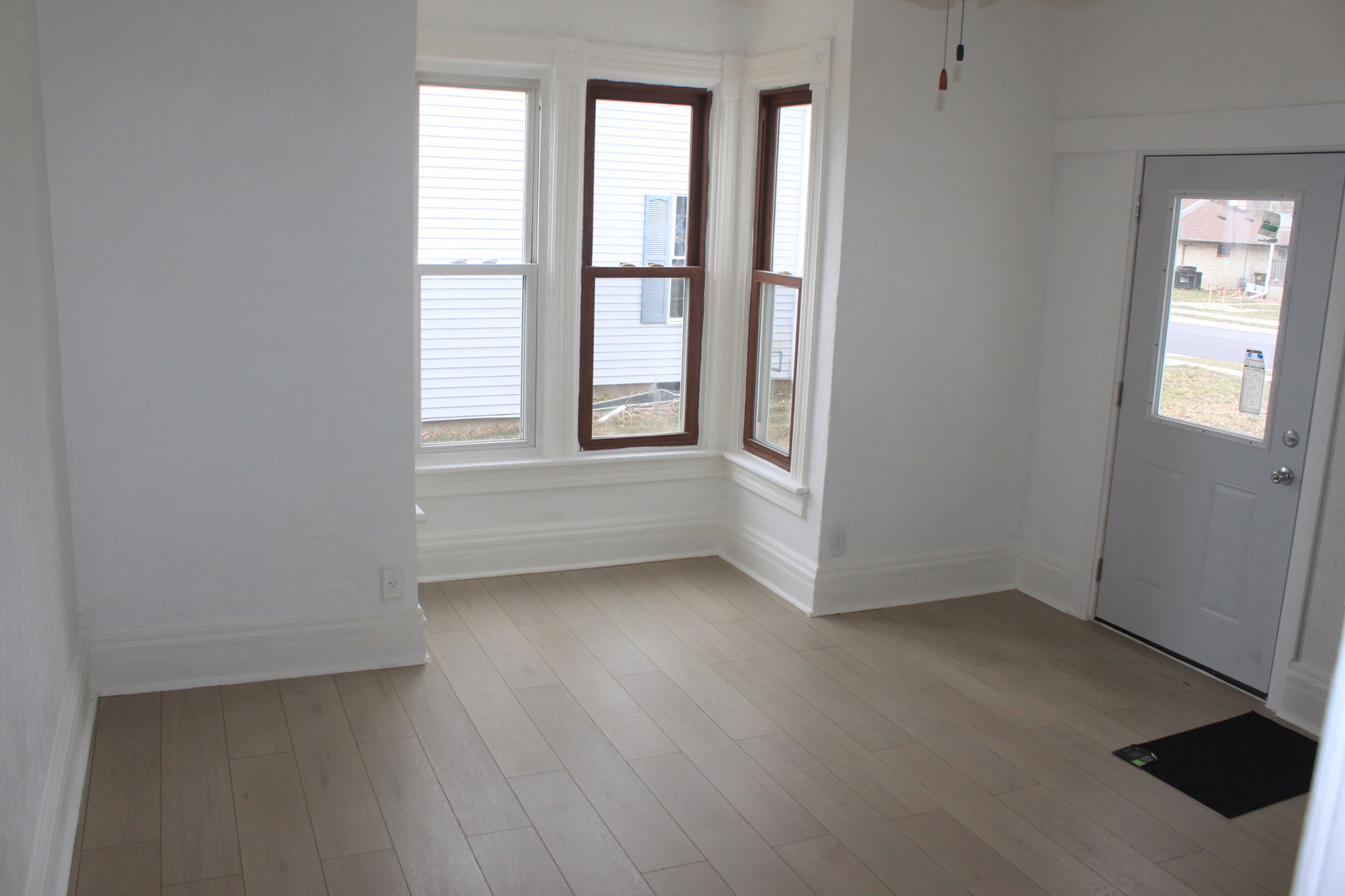 511 3rd Avenue Rock Falls, IL 61071 - Photo 4 of 9 an empty room with wooden floor and windows