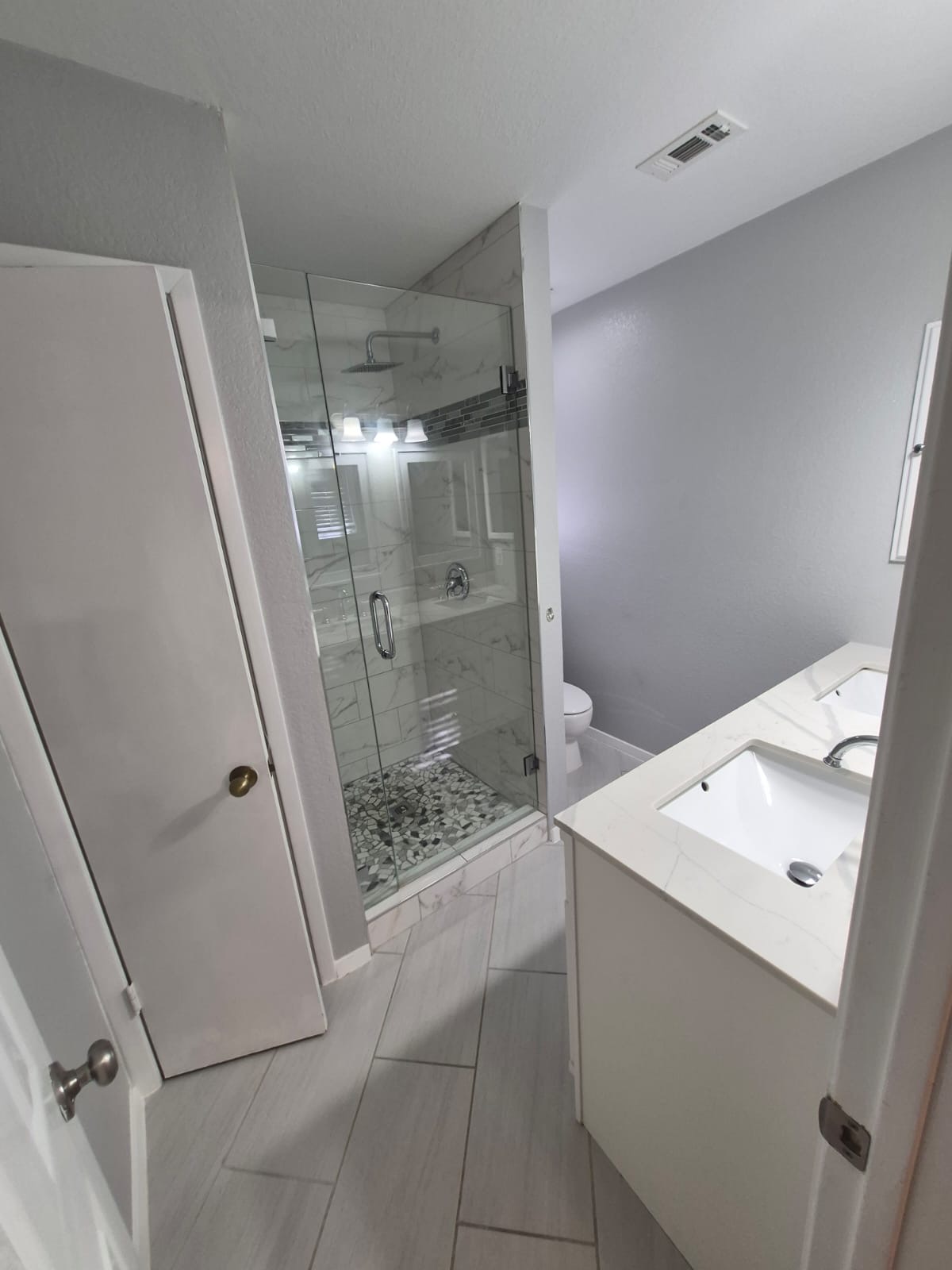 12915 Marimba Trail Austin, TX 78729 - Photo 9 of 15 Full bathroom with double vanity and a stall shower