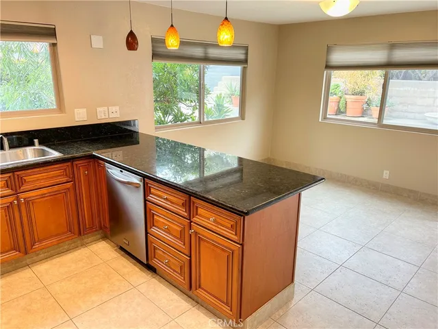 a kitchen with stainless steel appliances granite countertop a sink and a granite counter tops