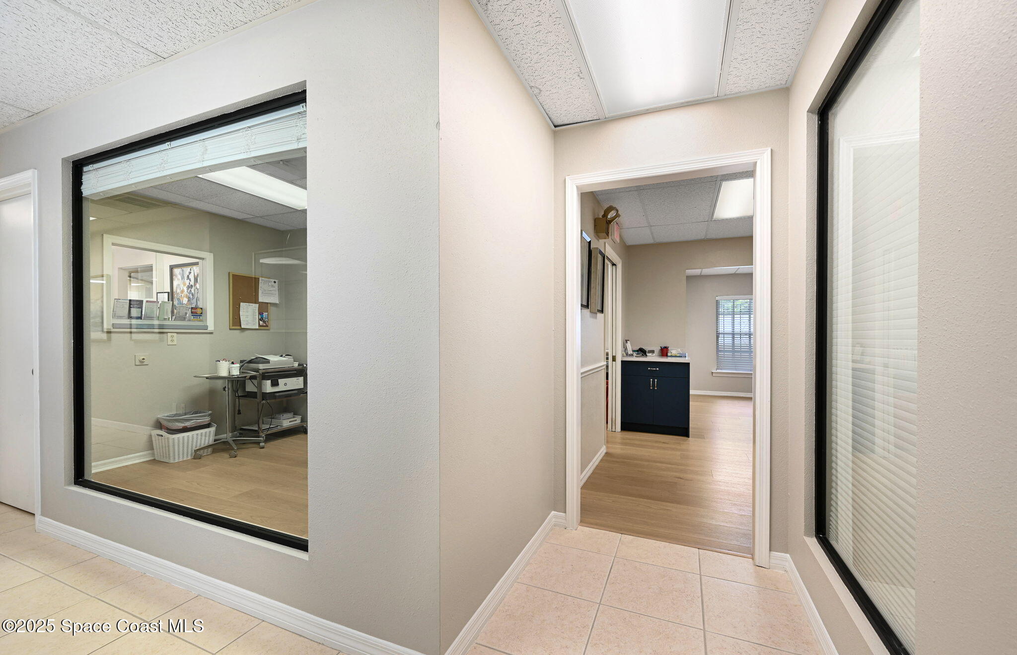 1801 Sarno Road, Unit 5 & 6 Melbourne, FL 32935 - Photo 15 of 44 a view of a hallway with wooden floor and a living room