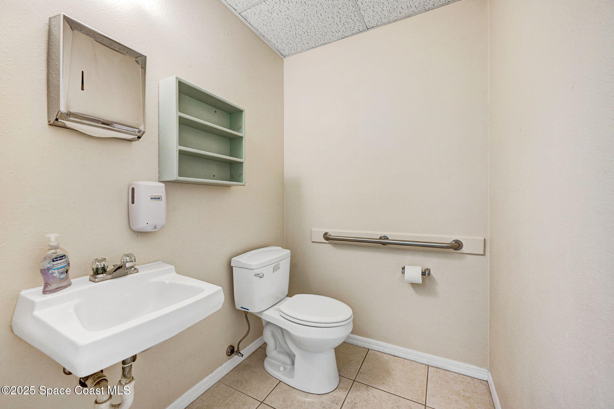 1801 Sarno Road, Unit 5 & 6 Melbourne, FL 32935 - Photo 27 of 44 a bathroom with a toilet a sink and mirror