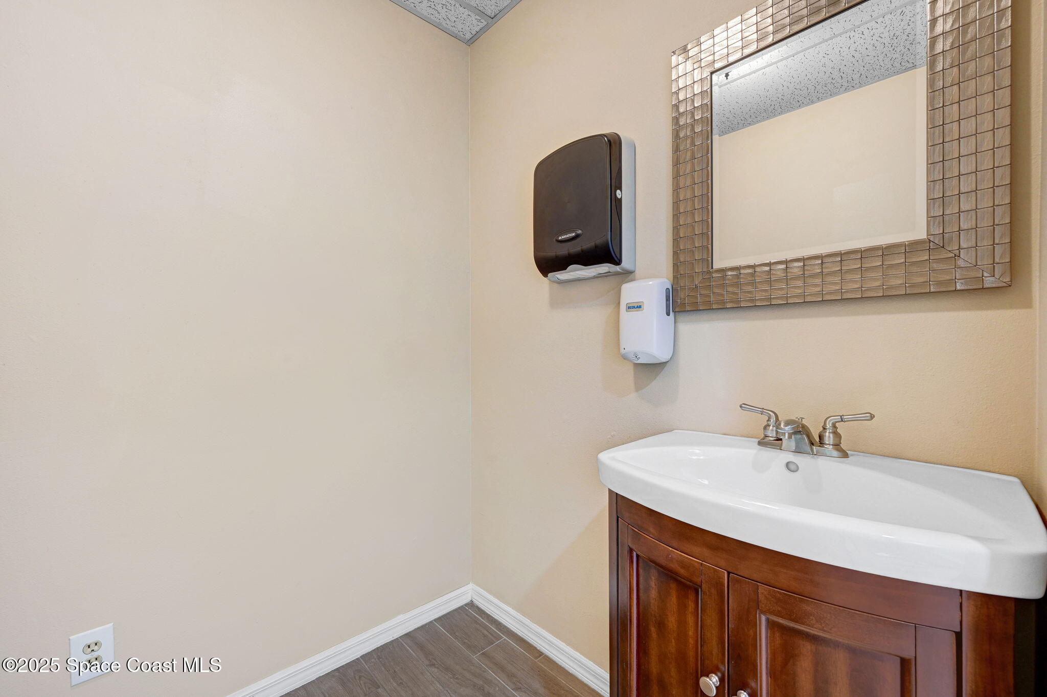 1801 Sarno Road, Unit 5 & 6 Melbourne, FL 32935 - Photo 31 of 44 a bathroom with a sink and a mirror