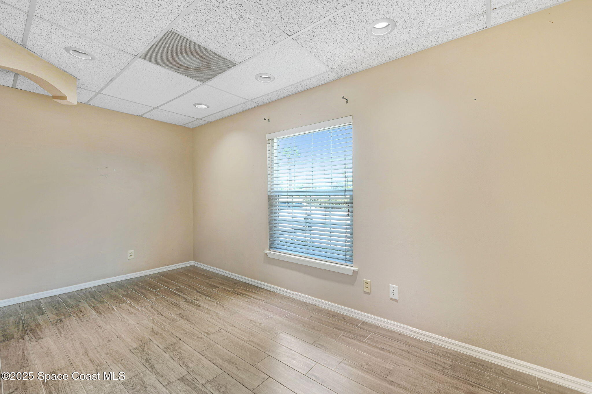 1801 Sarno Road, Unit 5 & 6 Melbourne, FL 32935 - Photo 32 of 44 an empty room with wooden floor and windows