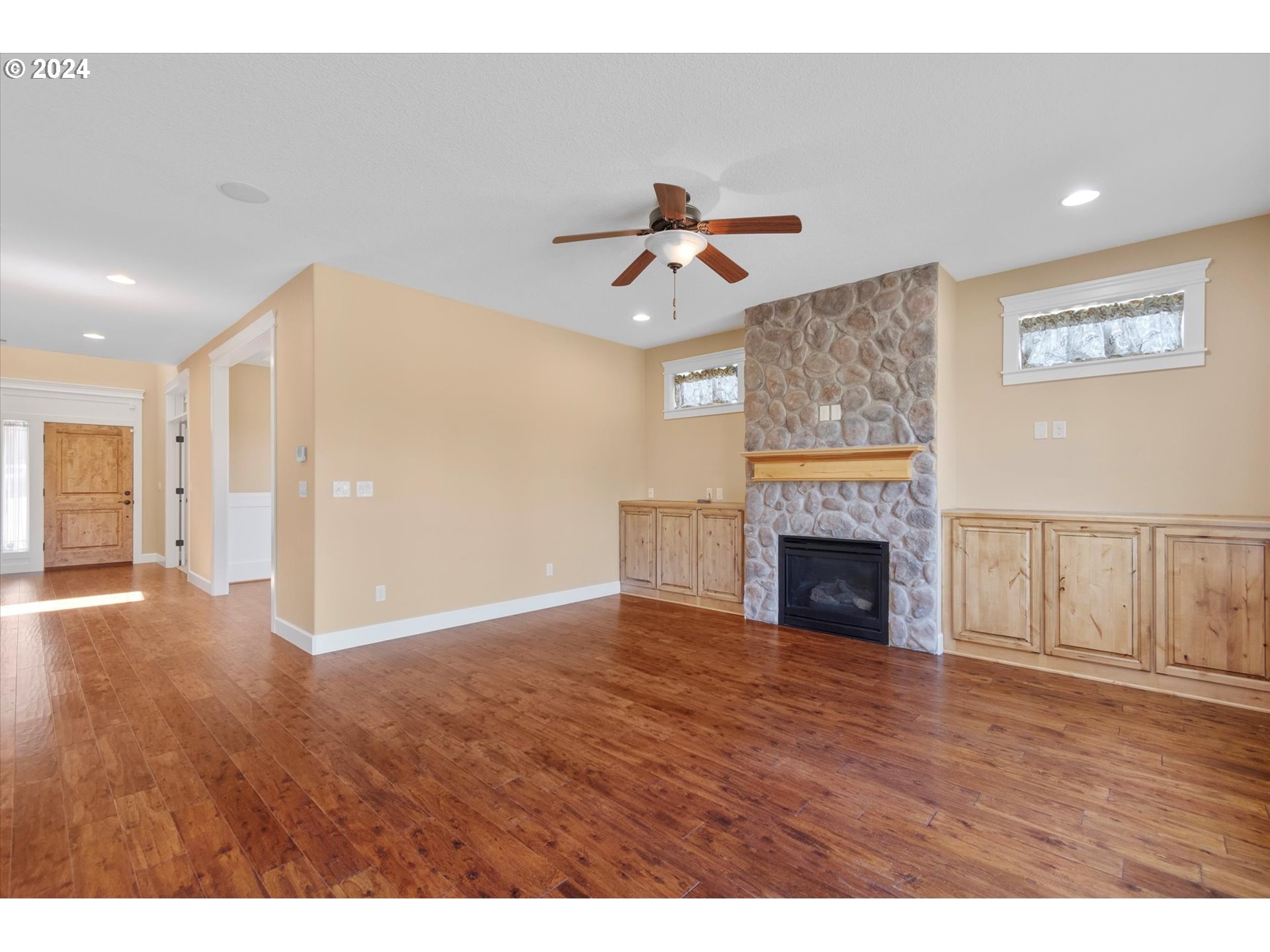 1760 South 18th Circle Ridgefield, WA 98642 - Photo 11 of 36 a view of a livingroom with a fireplace a chandelier and wooden floor