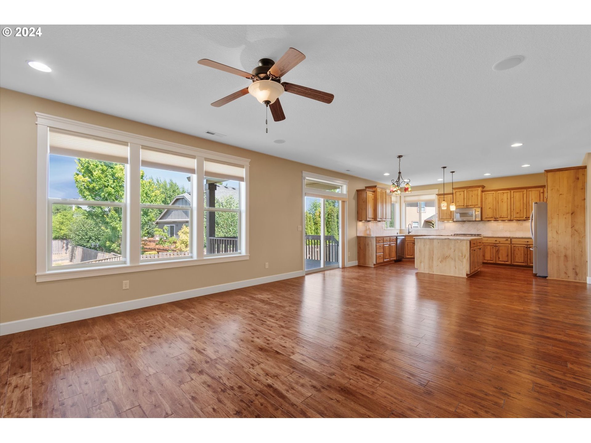1760 South 18th Circle Ridgefield, WA 98642 - Photo 12 of 36 a view of an empty room with wooden floor and a kitchen