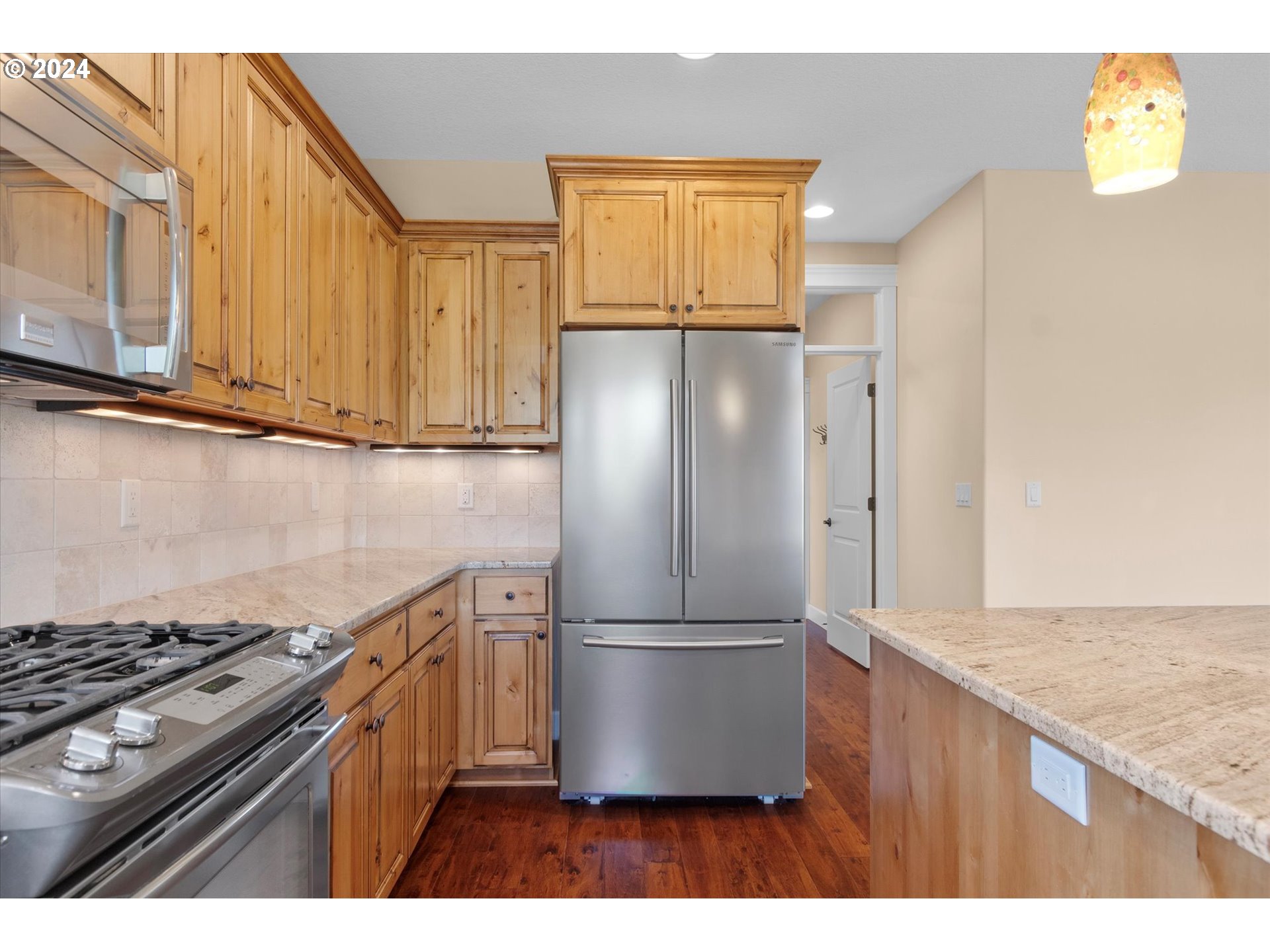 1760 South 18th Circle Ridgefield, WA 98642 - Photo 15 of 36 a kitchen with stainless steel appliances granite countertop a refrigerator a stove and a microwave