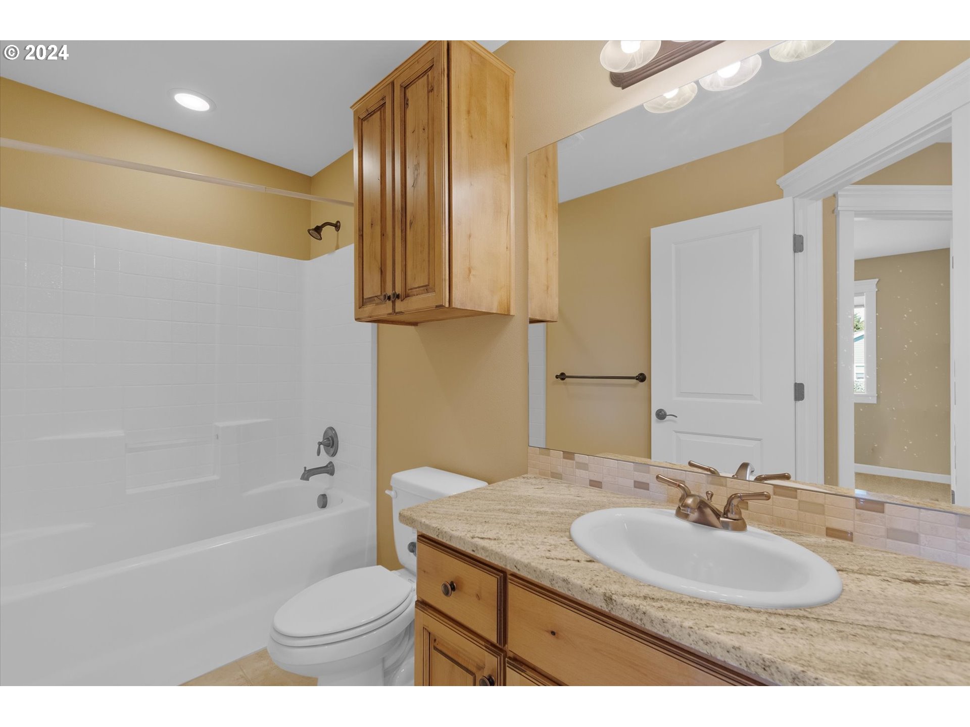 1760 South 18th Circle Ridgefield, WA 98642 - Photo 28 of 36 a bathroom with a granite countertop sink toilet and a bathtub