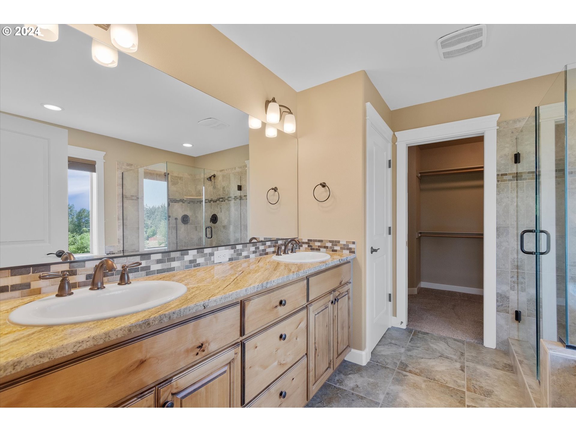 1760 South 18th Circle Ridgefield, WA 98642 - Photo 30 of 36 a bathroom with a granite countertop sink a large mirror and a shower