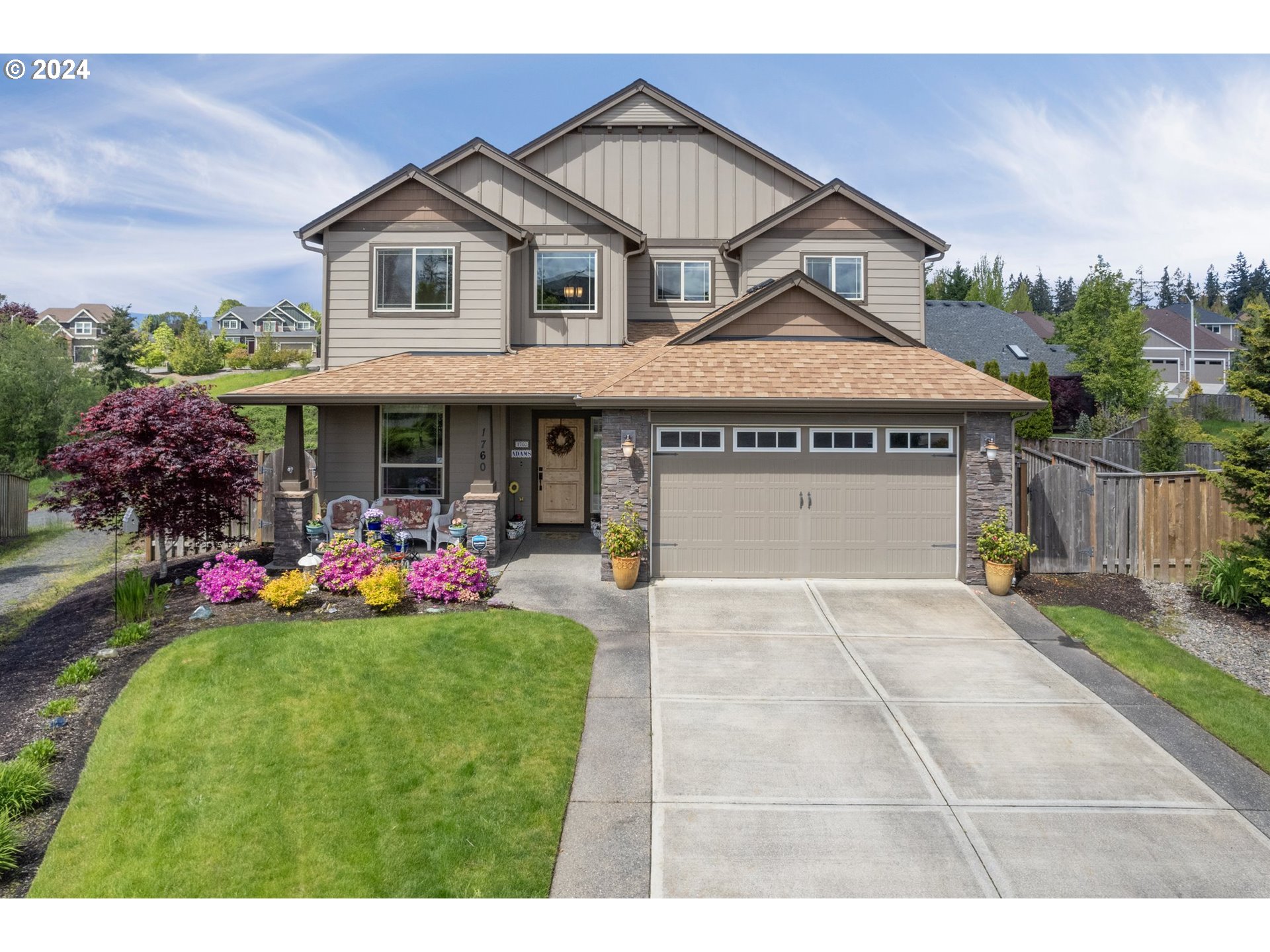 1760 South 18th Circle Ridgefield, WA 98642 - Photo 5 of 36 a front view of a house with a yard and garage