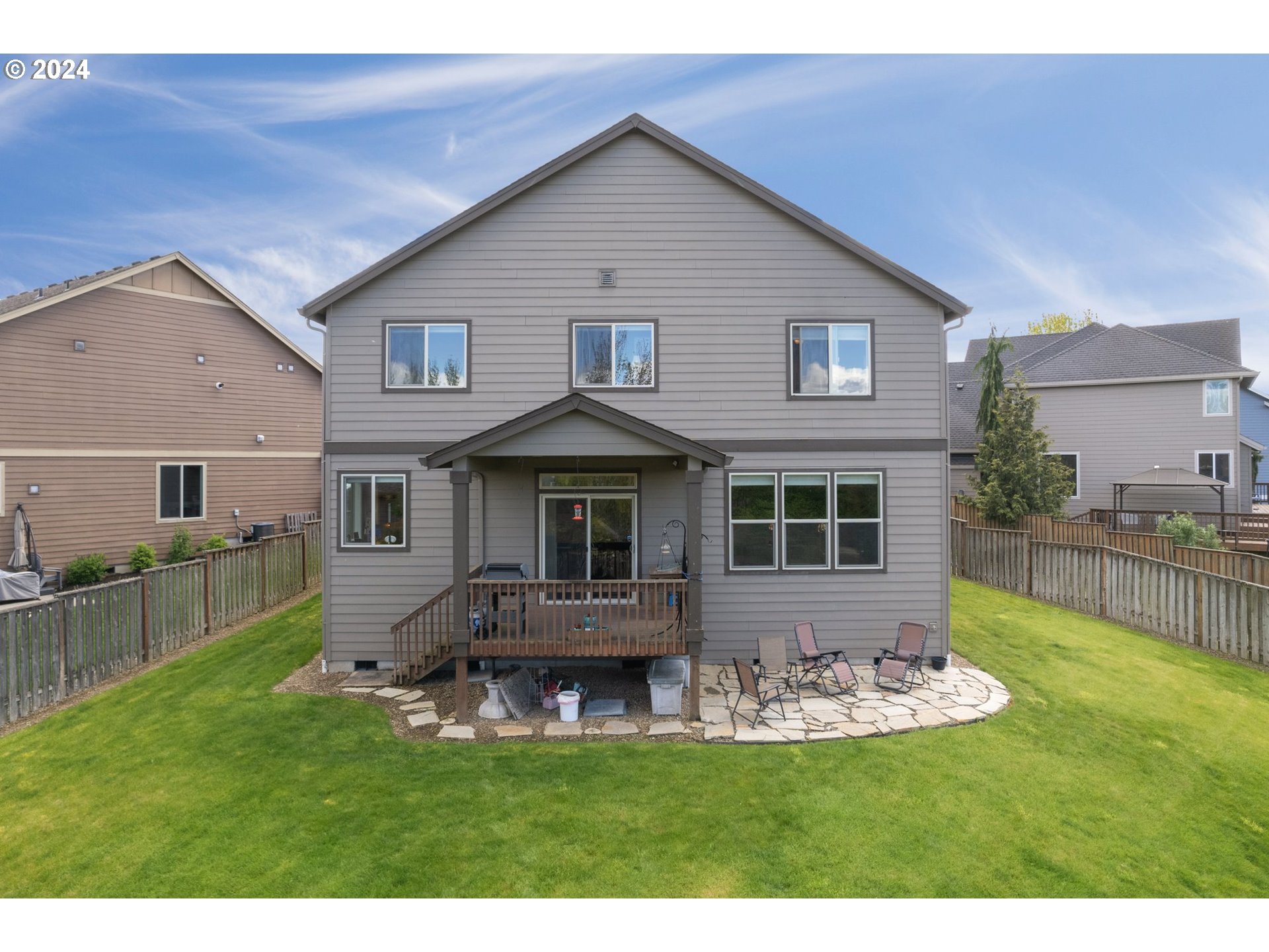 1760 South 18th Circle Ridgefield, WA 98642 - Photo 7 of 36 a front view of a house with a yard table and chairs