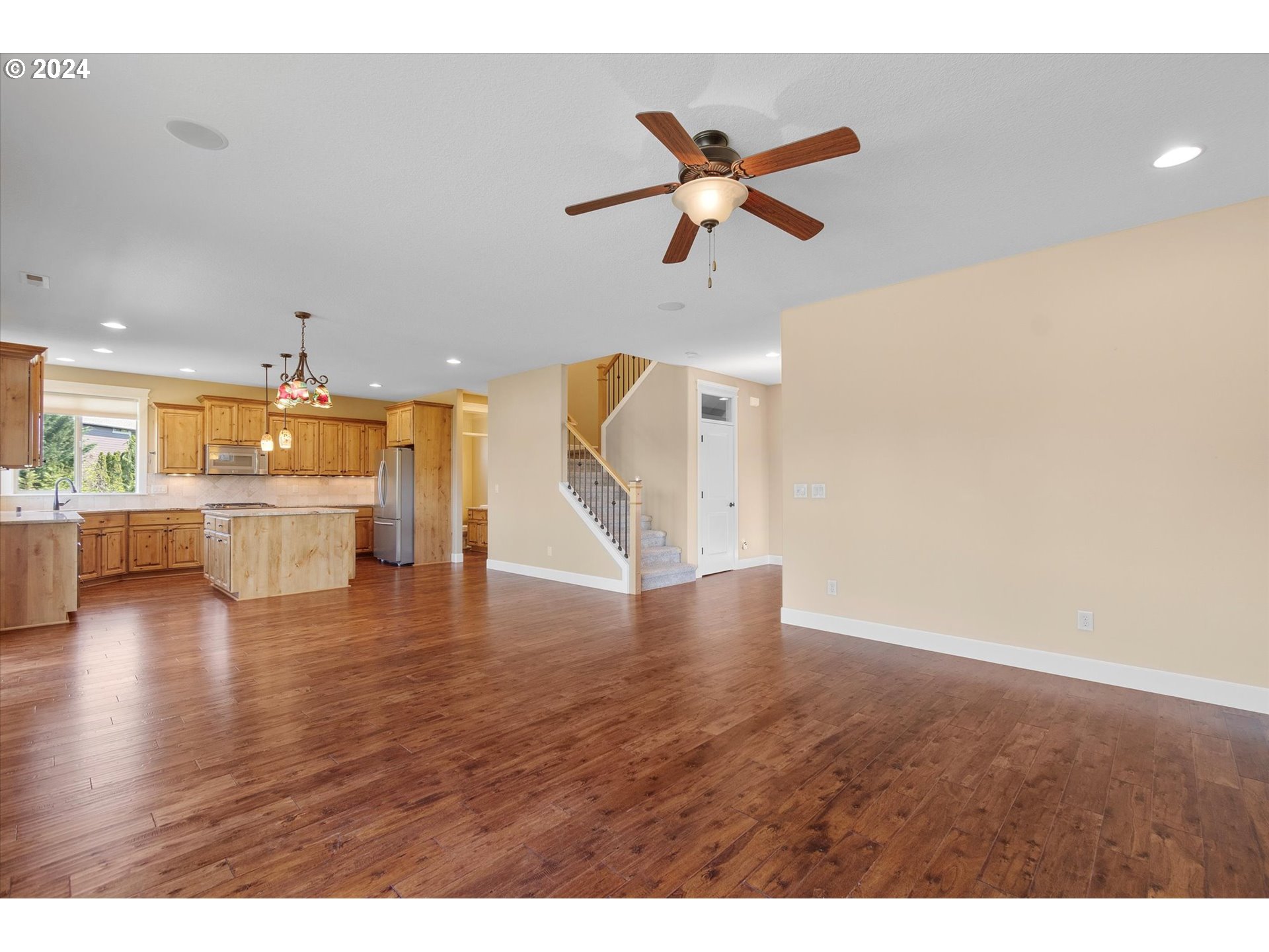 1760 South 18th Circle Ridgefield, WA 98642 - Photo 9 of 36 a view of an empty room with a window and wooden floor