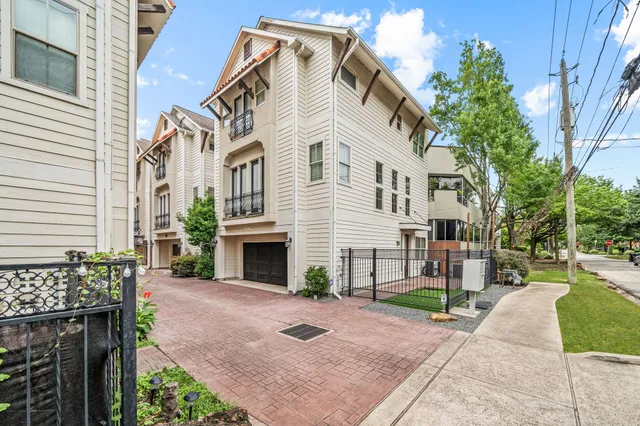 a view of a white house with a yard and table and chairs
